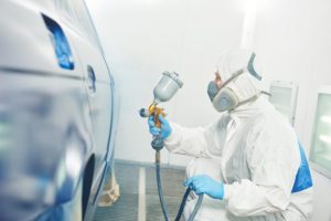 Man Painting The Body of the Car